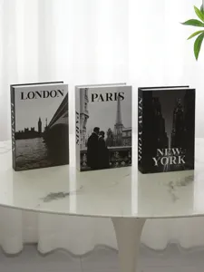 Detail view of decorative fake books with London, Paris and New York city designs.