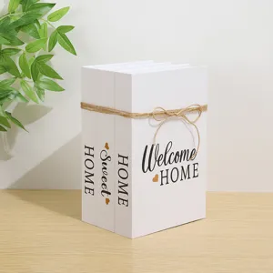 White decorative fake books set with twine bow and elegant English text for modern room decor
