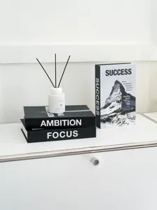 Minimalist black and white decorative fake books set with inspirational quotes for home office.