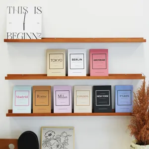 Colorful decorative fake books with city themes for bookshelf display and home decor.