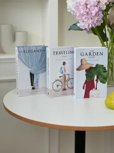 Decorative faux book detail showing three stylish minimalist photography props with nice covers.