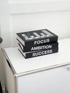 Minimalist decorative fake book stack with inspirational quotes, modern office and home decor.