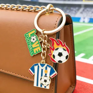 Detailed close-up of a stylish metal football keychain charm hanging on a bag for sports fans.