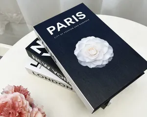 Close-up of decorative simulation books with Paris and flower design for home decor.