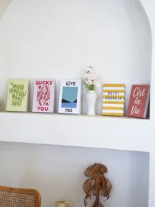Detailed shot of decorative fake book props with English typography for interior styling setup.