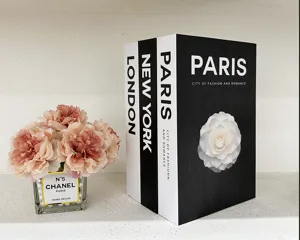 Decorative simulation book set with floral vase prop, modern black and white design.