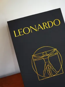 Detailed view of black linen texture decorative fake book storage box with gold Leonardo text.