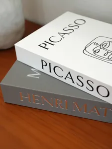Detailed view of luxury linen decorative fake book storage boxes with gold stamping art designs.