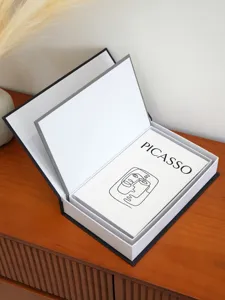 Decorative fake book storage box with Picasso art design, openable hollow organizer case.