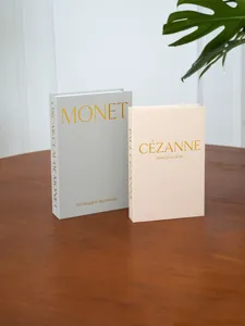 Linen-textured decorative fake book set featuring Monet and Cézanne art designs with gold foil.