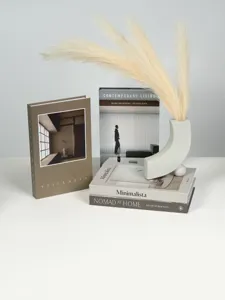 Minimalist decorative fake books set with modern vase detail, wabi-sabi earth tone home decor.