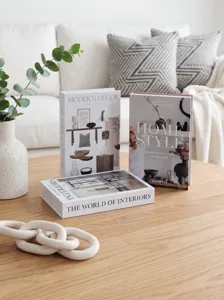 Decorative faux book set for coffee table interior styling and modern home decor display details.