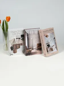 Detailed view of Nordic decorative faux books with modern minimalist covers and glass vase.
