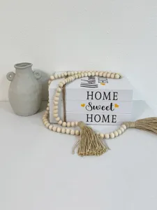 Decorative faux book storage box set with rustic wooden bead garland for home desktop decor.