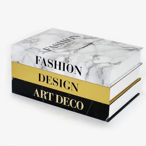 Decorative fake book stack with marble and gold design for modern home and hotel interior.