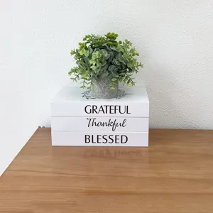 Decorative faux book storage box set with plants, rustic home decor display organizer.
