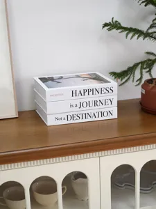 Decorative fake book prop set for home decor, featuring motivational quotes on the spine.