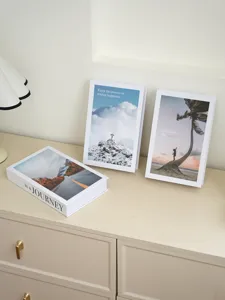 Detailed view of minimalist decorative fake books with English inspirational quotes for home decor.