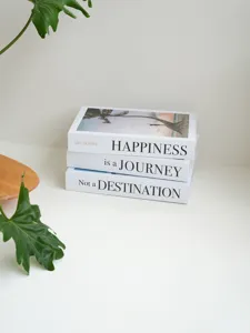 Decorative fake books set with inspirational quotes for modern home decor display.