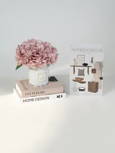 Nordic style decorative fake book box set with pink flower vase for modern home decor interior.