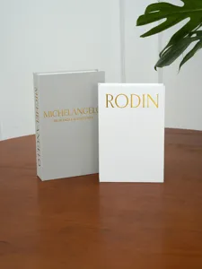 Decorative book detail, linen texture storage box with gold stamping for coffee table decor.