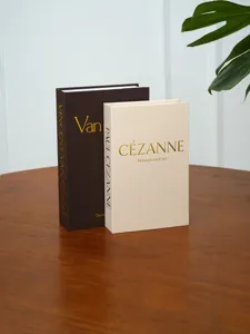 Detailed view of linen textured decorative fake books featuring Van Gogh and Cezanne themes.