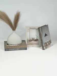 Detailed view of wabi-sabi earth tone decorative fake books, stylish home decor prop.