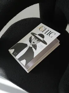 Detail view of black and white fashion decorative storage book prop on modern texture chair.