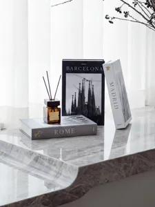 Detailed view of decorative European city fake book box set with elegant marble desktop setup.