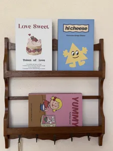 Details of decorative book boxes on wooden shelf, dopamine style aesthetic props for home.