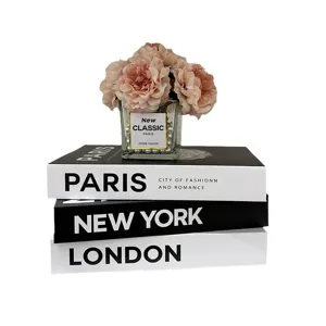 Decorative fake books set with floral vase, modern aesthetic table ornament for home decor.