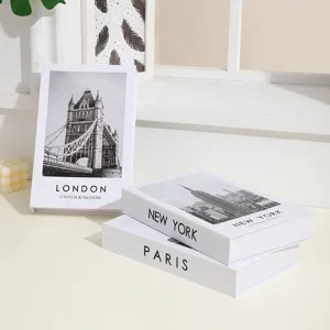 Detailed shot of decorative fake book props with famous city prints like London and Paris.