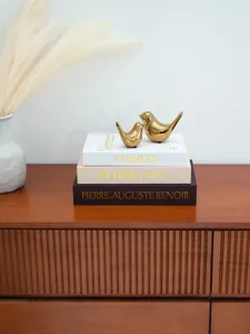 Decorative storage book set with gold foil art titles and golden bird decor items.