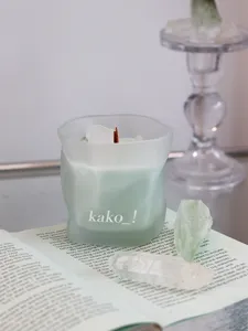 Frosted crystal scented candle detail, soothing ambient fragrance candle with raw stones for cozy home decor.