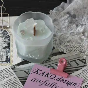 Detailed shot of frosted glass scented candle with crystal stones and wooden wick for decor.