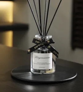 Close-up of a 120ml reed diffuser bottle with black sticks on a tray for home decor.