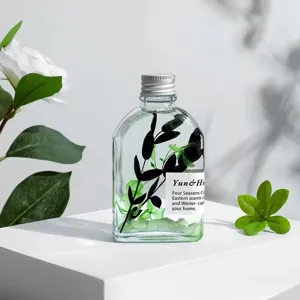 Flameless aromatherapy essential oil bottle with glowing stones and plant decor.