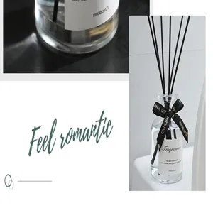 Glass reed diffuser bottle detail with black sticks and elegant ribbon decoration for home.