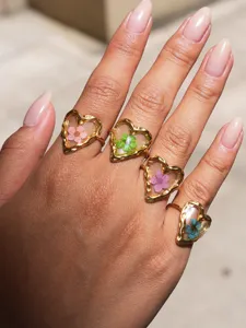Stainless steel heart resin dried flower ring detail view, delicate floral jewelry for women.