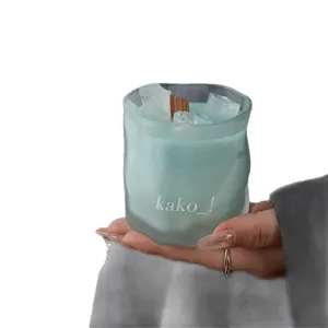 Frosted crystal scented candle with wooden wick and soothing blue wax for cozy home ambiance.