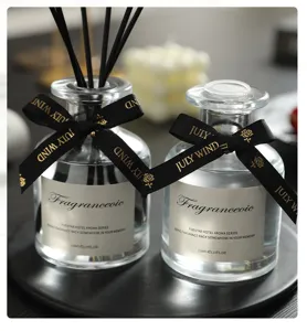 Glass reed diffuser bottle set with black sticks and elegant ribbon, 120ml home fragrance decor.