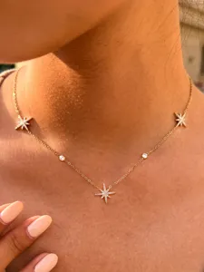 Detailed close-up view of delicate star pendant necklace featuring sparkly crystal stones.