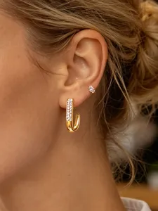 Gold J-shaped rhinestone hoop earrings for women, stylish stainless steel jewelry.