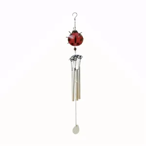 Detailed view of a charming metal ladybug wind chime with hanging tubes and cute garden decor.