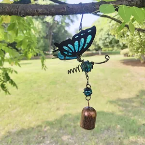 Hanging butterfly wind chime with blue glass wings, metal frame and bell for garden decor.