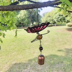 Detailed shot of a 3D butterfly wind chime with colorful glass wings and a metal bell.