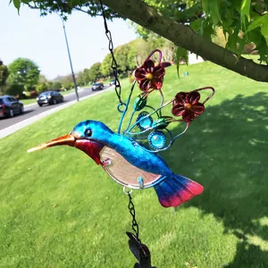 Detailed view of colorful iron art and glass hummingbird hanging decoration yard item.