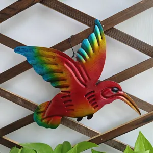 Metal hummingbird wall decor detail showing vibrant colored iron bird for indoor and outdoor garden.