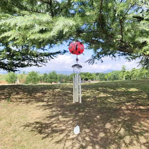 Outdoor hanging metal wind chime featuring a cute red ladybug design and clear sounding tubes.