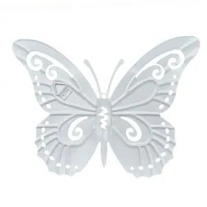 White metal butterfly wall hanging detail showing back hook and hollow carved craft design.